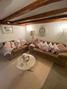 a living room with two couches and a table at ‘The Nest’ A beautiful cottage in Devon in Axminster