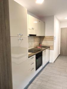 a kitchen with white cabinets and a counter top at Perfect Place for two in Kranj