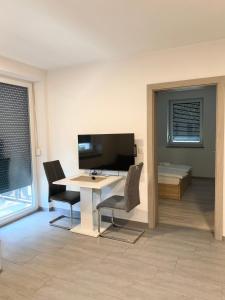 a room with a desk and two chairs and a bed at Perfect Place for two in Kranj