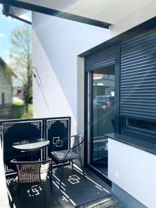 a patio with a table and chairs on a balcony at Perfect Place for two in Kranj