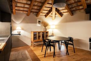a kitchen and dining room with a table and chairs at Casa del Vicario in Fagagna