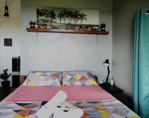 a bedroom with a bed with a pink bedspread at Shambala Paradise in Siquijor