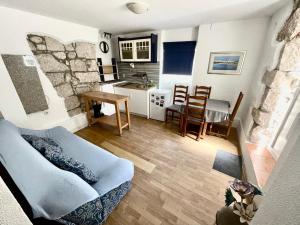 a living room with a couch and a table at Apartments Rome in Baška