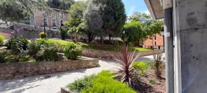 a view of a garden with plants and a building at Piso Covian in Ribadesella
