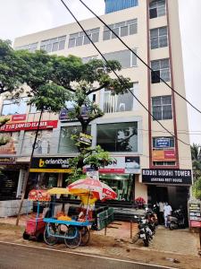 a store with an umbrella in front of a building at Ashiyana Rest House in Deoghar