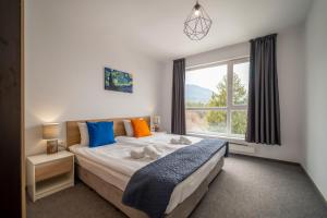 a bedroom with a bed and a window at Saint George Palace Aparthotel in Bansko