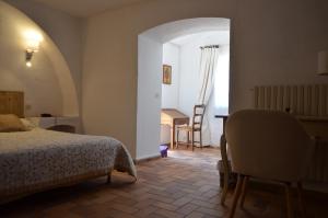 a bedroom with a bed and a table and a chair at La Pierrerie in Grimaud +60 photos
