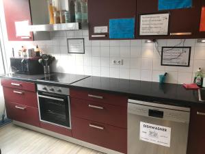 a kitchen with a stove top oven and a counter top at Dutchies Hostel in Amsterdam