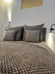 a bedroom with a large bed with two pillows at Apartmenthaus Stade Schwingewiesen Apartment 2 in Stade