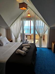a bedroom with a bed with a view of the ocean at Silver Continent Hostel in Silivri