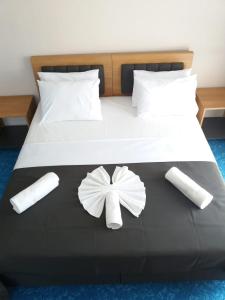 a white bed with a bow decoration on it at Silver Continent Hostel in Silivri