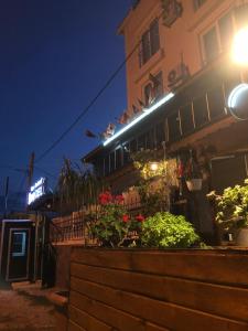 a building with flowers in front of it at night at Silver Continent Hostel in Silivri