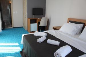 a bedroom with a bed with two towels on it at Silver Continent Hostel in Silivri