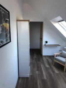 an attic room with a door and a chair at Pension Highway Bünde Hansastraße in Bünde