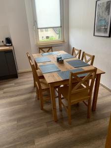 a wooden table and chairs in a room at Pension Highway Bünde Hansastraße in Bünde