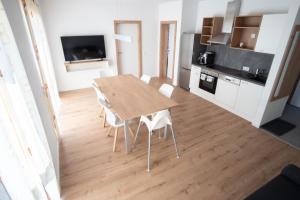 a kitchen and dining room with a wooden table and chairs at Family XL - Bungalows in Lutzmannsburg