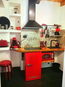 a kitchen with a red cabinet and a red stove at Spiaggia da Monic in Trevignano Romano