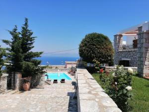 a villa with a swimming pool and the ocean at Malvazios Villas family apartment with view in Gythio