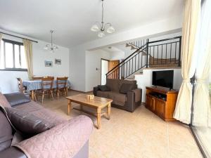 a living room with a couch and a table at Spacious 3 bedroom villa private pool in Paphos