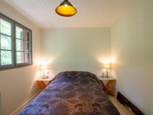 a bedroom with a bed and two tables with lamps at La Pichona in Carlux