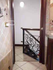 a bathroom with a black railing next to a door at casetta sul porticciolo in Stintino