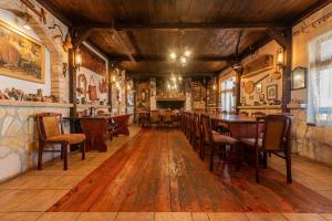 a restaurant with wooden tables and chairs and a bar at Villa Štrkalj ZadarVillas in Murvica +55 photos