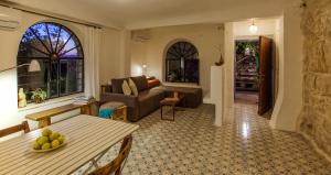 a living room with a couch and a table at The Nest - A Romantic Vacation Home in Ein Kerem - Jerusalem in Jerusalem