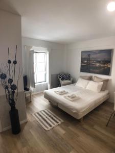 a bedroom with a bed and a vase of flowers at LX Lisboa Cozy studio in Lisbon