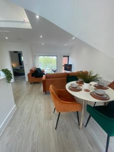 a living room with a table and chairs and a couch at Kings Mile House in Canterbury