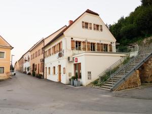 un edificio blanco con una escalera delante en Fado Apartments Gornja Radgona, en Gornja Radgona