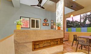 a living room with a fireplace and a table at Treebo Trend Seabreeze Comforts in Visakhapatnam