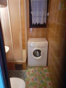 a small bathroom with a toilet and a sink at Josip 2 Gajac in Novalja