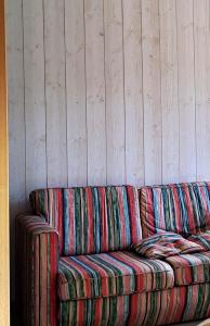 a colorful couch sitting against a wall at Auberge du Glandon in Saint-Colomban-des-Villards +8 photos