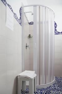 a bathroom with a shower with a stool in it at Hotel La Terrazza in Panarea
