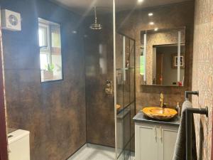 a bathroom with a sink and a shower at The Fuggle in Whaplode
