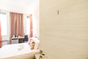 a bedroom with a bed with stuffed animals on it at Erreggi Luxury Rooms in Rome
