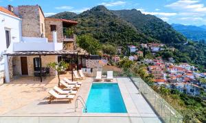 a villa with a swimming pool and a view of a city at Villa Barozziana Private Heated Pool & Jacuzzi in Rethymno Town