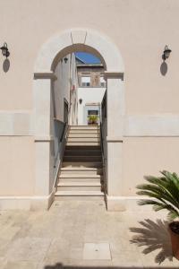 an archway leading up to a building with stairs at Boutique Hotel Molo S Lucia in Syracuse
