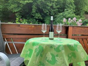 a bottle of wine and two glasses on a table at Weingut Piewald in Gut am Steg