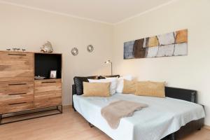 ein Schlafzimmer mit einem Bett und einer Kommode in der Unterkunft Seepark Lindenallee Wohnung 2f-1 Waterkant Scharbeutz in Scharbeutz