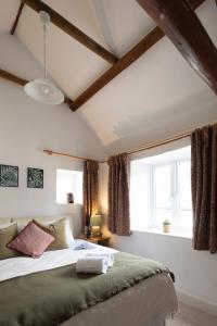 a bedroom with a large bed and a window at Character cottage in the heart of Uplyme. in Uplyme