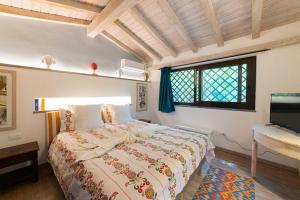 a bedroom with a bed and a window at Etna Botanic Garden in Mascalucia
