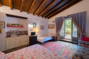 a bedroom with a bed and a window at Etna Botanic Garden in Mascalucia