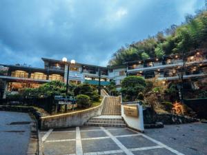 a building with a staircase in front of it at LiVEMAX RESORT Okudogo in Matsuyama