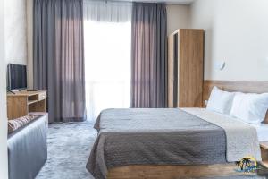 a hotel room with a bed and a television at Gradina Holiday in Sozopol +55 photos