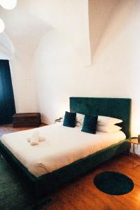 a bedroom with a large bed with blue pillows at Franz Haus Apartments in Merano