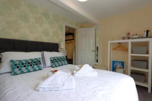 a bedroom with a bed with towels on it at The Little Lion Inn, Red Lion in Wellingore