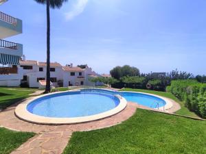 a swimming pool in a yard next to a house at Terraza con vistas espectaculares - Haciendas ALBERT VILLAS Alcossebre in Alcossebre