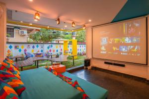 a room with a large screen with a play room at goSTOPS Goa, Baga in Baga