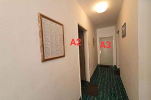 a hallway with two numbers on the wall and a picture on the wall at Apartments in Porec/Istrien 40404 in Poreč